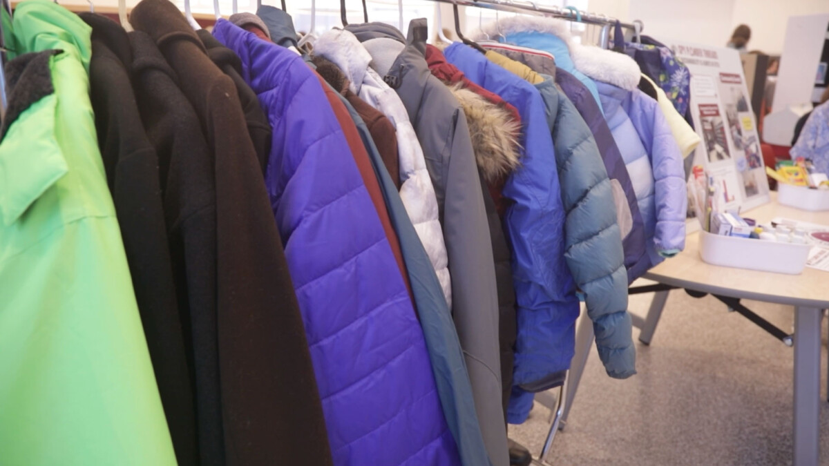 A clothing rack filled with winter coats